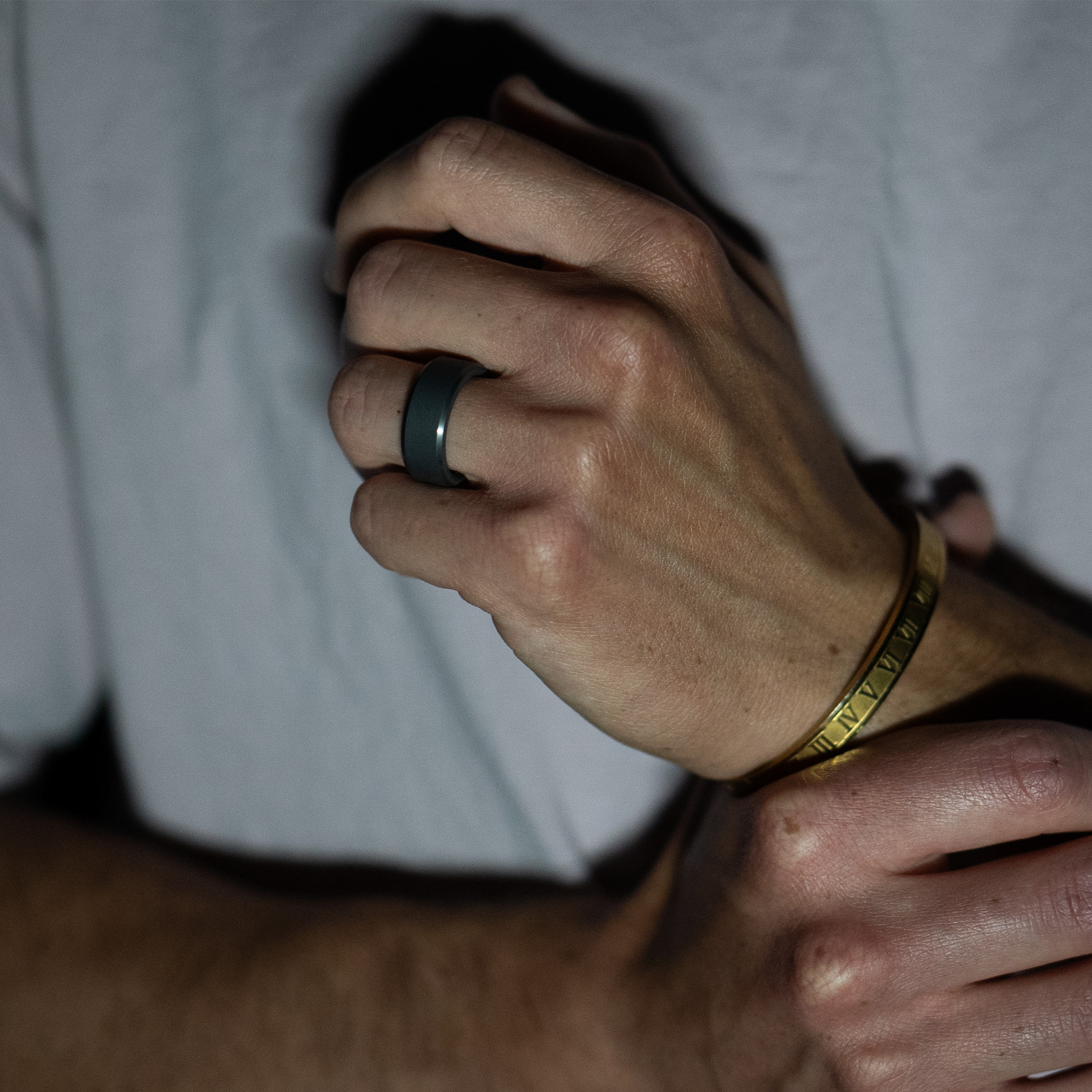 Photo of beveled, matte, Elysium Black Diamond ring on hand